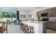 Open concept kitchen with island, stainless steel appliances, and view to living room at 2073 Hallier Cv, Wesley Chapel, FL 33543