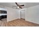 Bedroom with wood floors, ceiling fan, and kitchen view at 3005 E Shadowlawn Ave, Tampa, FL 33610
