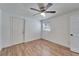 Bedroom with wood floors, ceiling fan and access to laundry at 3005 E Shadowlawn Ave, Tampa, FL 33610