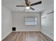 Bedroom with wood floors, ceiling fan and window at 3005 E Shadowlawn Ave, Tampa, FL 33610