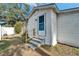 White house exterior with gray trim, steps and a teal door at 3005 E Shadowlawn Ave, Tampa, FL 33610