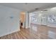 Open living room with hardwood floors and laundry area at 3005 E Shadowlawn Ave, Tampa, FL 33610