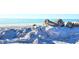 Tranquil beach scene with a white sandy shore and clear blue ocean water at 308 2Nd St N # 202, Bradenton Beach, FL 34217