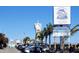 Streetscape view featuring Historic Bridge Street Pier with restaurants and retail in a tropical setting at 308 2Nd St N # 202, Bradenton Beach, FL 34217