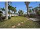 Spacious backyard with grassy area and tropical plants at 311 15Th Ave, Indian Rocks Beach, FL 33785