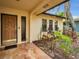 Front porch with wooden door and side garden at 311 15Th Ave, Indian Rocks Beach, FL 33785