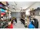 Overstuffed garage with shelving and workbench at 311 15Th Ave, Indian Rocks Beach, FL 33785