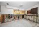 A kitchen in need of renovation, showing exposed pipes and framing at 311 15Th Ave, Indian Rocks Beach, FL 33785