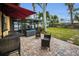 Backyard patio with seating area and screened enclosure at 311 15Th Ave, Indian Rocks Beach, FL 33785