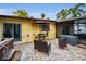 Relaxing patio with hot tub, seating area, and umbrella at 311 15Th Ave, Indian Rocks Beach, FL 33785