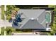 Aerial view of the home's roof, with a screened-in pool and landscaped yard at 3121 Silvermill Loop, Land O Lakes, FL 34638