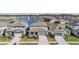 Aerial view of homes surrounding a pond with a fountain at 3888 Almond Brook Blvd, Land O Lakes, FL 34638