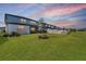 View of a backyard featuring a white fence, grass, and side of the house at 3888 Almond Brook Blvd, Land O Lakes, FL 34638