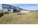 View of a backyard featuring a white fence, grass, and side of the house at 3888 Almond Brook Blvd, Land O Lakes, FL 34638