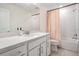 Modern bathroom features white cabinets, white subway tiles, and a shower-tub combo at 3888 Almond Brook Blvd, Land O Lakes, FL 34638
