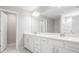 Bathroom featuring a double vanity with white countertops, cabinets, and modern lighting at 3888 Almond Brook Blvd, Land O Lakes, FL 34638