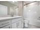 Modern bathroom featuring white subway tile, double sinks, and a shower-tub combo at 3888 Almond Brook Blvd, Land O Lakes, FL 34638