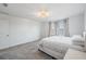 Bedroom with carpet, queen bed with white bedding, chandelier, and curtains over the windows at 3888 Almond Brook Blvd, Land O Lakes, FL 34638