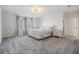 Bedroom with carpet, a queen bed with white bedding, side table, and curtains over the windows at 3888 Almond Brook Blvd, Land O Lakes, FL 34638