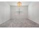 Bright, empty room with plush carpeting, a modern chandelier, and a window at 3888 Almond Brook Blvd, Land O Lakes, FL 34638