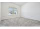 Bright, neutral empty room with soft carpeting and a window with natural light at 3888 Almond Brook Blvd, Land O Lakes, FL 34638