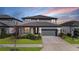 Charming two-story home featuring a manicured lawn and a two-car garage, perfect for Gathering living at 3888 Almond Brook Blvd, Land O Lakes, FL 34638