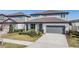Inviting two-story home with a lush lawn and a practical two-car garage, providing comfort and convenience at 3888 Almond Brook Blvd, Land O Lakes, FL 34638