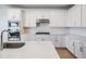 Well-lit kitchen features stainless steel appliances, gas cooktop, and bright backsplash at 3888 Almond Brook Blvd, Land O Lakes, FL 34638