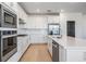 Modern kitchen with white cabinets, stainless steel appliances, and sleek countertops at 3888 Almond Brook Blvd, Land O Lakes, FL 34638