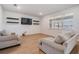 Cozy living room with wood floors, large window, and comfortable seating at 3888 Almond Brook Blvd, Land O Lakes, FL 34638