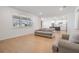 Bright living room featuring wood floors, comfortable seating, and natural light at 3888 Almond Brook Blvd, Land O Lakes, FL 34638