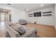 Open living room with wood flooring, TV, and comfortable seating at 3888 Almond Brook Blvd, Land O Lakes, FL 34638
