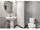 Stylish powder room with a pedestal sink and modern fixtures at 3888 Almond Brook Blvd, Land O Lakes, FL 34638