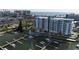 Aerial view of modern condo building with marina, pool, and waterfront access near the beach at 411 E Shore Dr # 313, Clearwater Beach, FL 33767