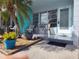 Inviting front porch with seating area and lush landscaping and turquoise accents at 4140 55Th N St # 1115, Kenneth City, FL 33709