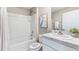 Small bathroom with shower/tub combo, white vanity, and gray tile at 4456 Sand Dollar Way, Zephyrhills, FL 33541