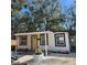 Renovated home with yellow door and covered patio at 5152 Filbert St, Zephyrhills, FL 33541