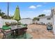 Patio furniture beneath an umbrella on a flagstone patio at 5152 Victoria Ln, Holiday, FL 34690
