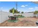 Relaxing patio with seating area, table, and artificial turf at 5152 Victoria Ln, Holiday, FL 34690