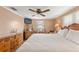 King-size bed, wood furniture, and ceiling fan in bright bedroom at 5152 Victoria Ln, Holiday, FL 34690