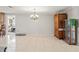 Dining room with tile floor, chandelier, and wooden cabinet at 5152 Victoria Ln, Holiday, FL 34690