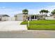 Single story home with attached garage and lawn at 5152 Victoria Ln, Holiday, FL 34690