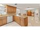 Open kitchen with granite island and wood cabinets at 5152 Victoria Ln, Holiday, FL 34690