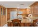 Kitchen boasts granite counters, wood cabinets and breakfast bar at 5152 Victoria Ln, Holiday, FL 34690