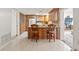 View of kitchen island with granite countertop and two wood chairs at 5152 Victoria Ln, Holiday, FL 34690