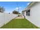 Side yard with grassy area and white fence at 5152 Victoria Ln, Holiday, FL 34690
