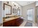 Bathroom featuring dual sinks, a large countertop, and a walk-out door at 5501 E Longboat Blvd, Tampa, FL 33615