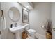 Well-maintained bathroom featuring a pedestal sink, toilet, and decorative accents at 5501 E Longboat Blvd, Tampa, FL 33615