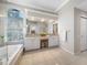 Bright bathroom features a double sink vanity, soaking tub, and large windows at 5501 E Longboat Blvd, Tampa, FL 33615