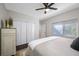 Bedroom featuring a bed with a white blanket, a dresser, and a window at 5501 E Longboat Blvd, Tampa, FL 33615